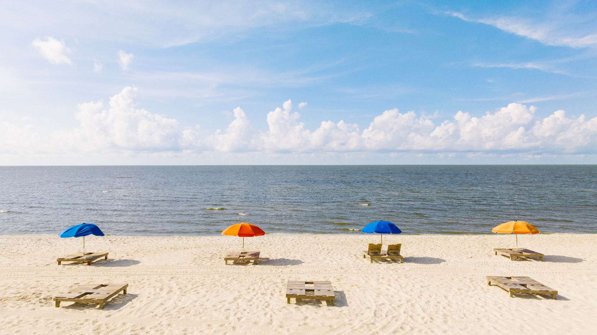 Colourful umbrellas on the white sands of Biloxi Beach