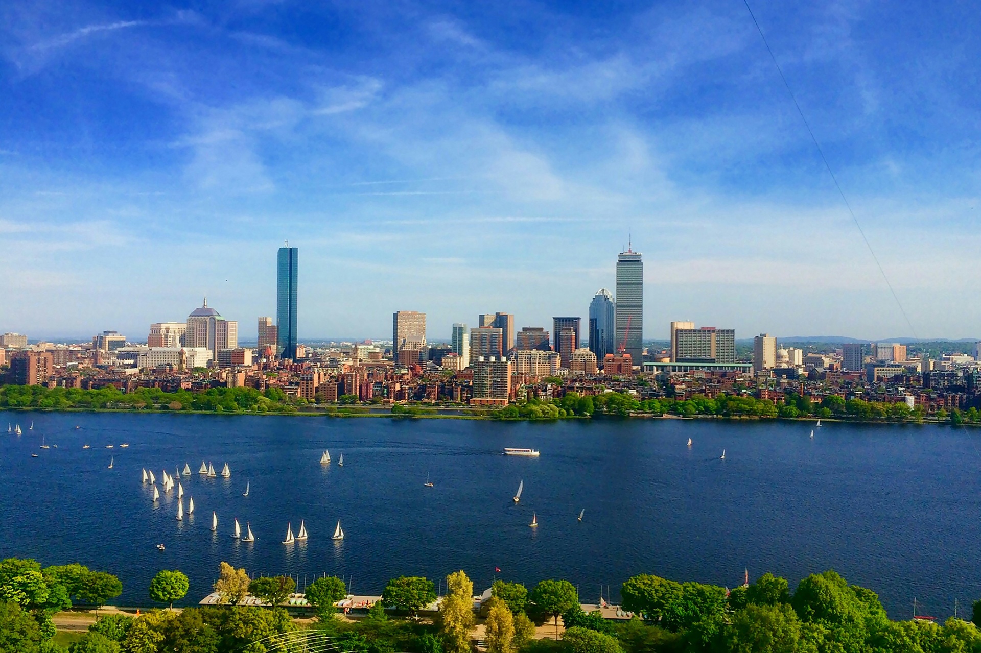 The Boston skyline across the Charles River with sailboats